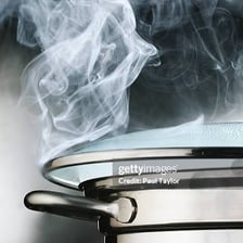 Steam rising from a pot of boiling water