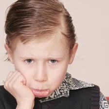 A person making a visibly sullen, pouty facial expression