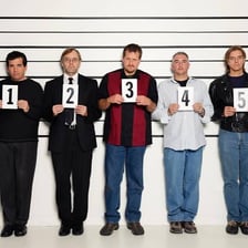 A witness points toward a person during an identification procedure.
