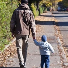 A father walking with a child