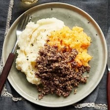 A serving of haggis with mashed turnips and potatoes