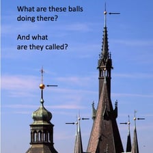 A pointed spire rising from a church steeple.