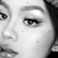 A close-up portrait showing a beauty mark on the face