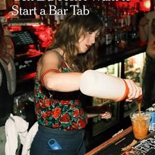 A customer at a bar having purchases added to a running tab.