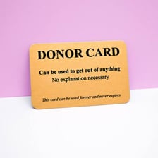 An organ donor card shown beside or inside a wallet.