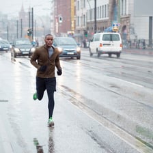 A person hurrying through a busy city street