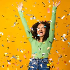 A person celebrating with an expression of great happiness.