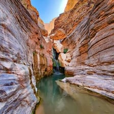 A deep natural chasm separating two sides of rocky terrain