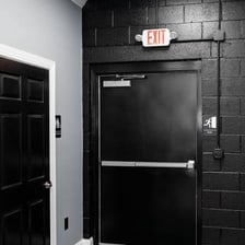 A doorway marked with an illuminated exit sign