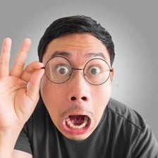 A person making an exaggerated shocked reaction