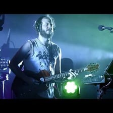 Bon Iver performing onstage.