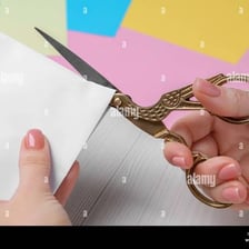 Scissors making a short cut through a piece of paper.