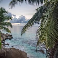 A remote island with a sandy shore and sparse landscape.