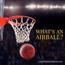A basketball flying completely clear of the hoop
