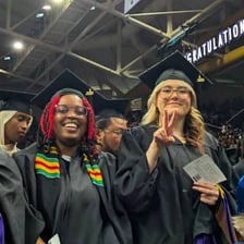 A creative-writing graduate receiving or displaying a Master of Fine Arts degree.