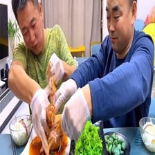 A person keeping a plate of food to themselves while others look on