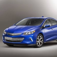 A Chevrolet Volt electric car is shown on a road.