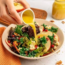 Several bowls of vinaigrette dressing prepared for a salad.
