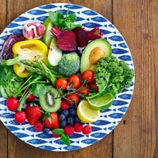 Fresh unprocessed fruits and vegetables arranged on a table