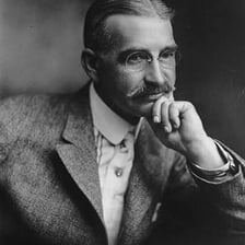 A portrait of L. Frank Baum beside an edition of The Wonderful Wizard of Oz.