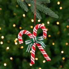 A red-and-white striped candy cane with its characteristic hooked shape.