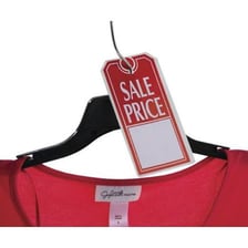 A retail worker attaching a sale tag to clothing.