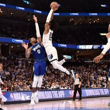 A basketball player leaping toward the hoop.