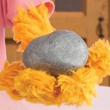 Sesame Street character Zoe with her pet rock, Rocco.