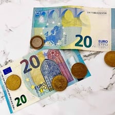 Euro banknotes and coins associated with currency in France