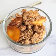A baked apple crisp covered with a crumbly streusel topping