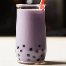 A purple taro-flavored boba milk tea with tapioca pearls.