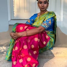 A woman wearing a traditionally draped Indian sari