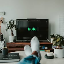 A person watching an online video stream on a television