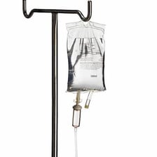 A clear intravenous fluid bag hanging from a hospital IV pole