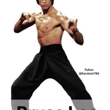 Bruce Lee demonstrating a martial arts pose.