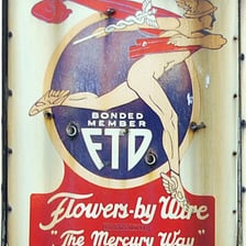 FTD logo featuring Mercury holding flowers