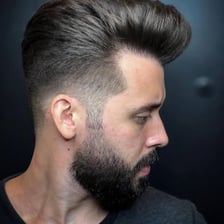 A haircut with gradually faded sides and a longer top