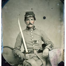 A historical image of a Confederate soldier in Civil War uniform.
