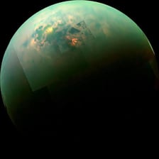 Titan shown as Saturn’s hazy orange moon in space