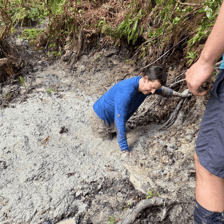 A person navigating a muddy bog.