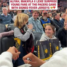 Fans in a crowd reacting to a moment during a sporting event.