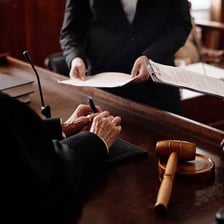 A lawyer submitting legal documents at a courthouse