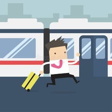 A person hurrying toward a train platform