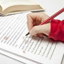 An editor marking a manuscript for cuts