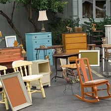 Furniture and household belongings displayed for sale inside a home.