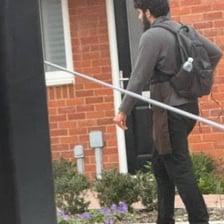 A person standing outside a closed door and announcing their identity.