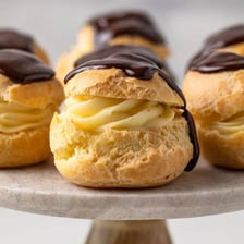 A cream-filled pastry dusted with powdered sugar.