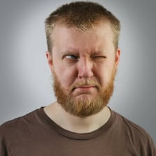A person looks sideways without turning their head fully.