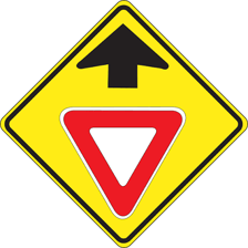 A red Stop sign beside a triangular Yield sign