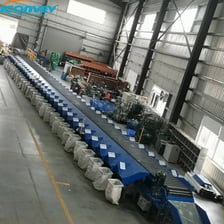 An industrial machine sorting objects on a conveyor belt